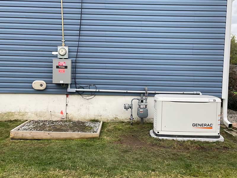 A Generator and Water Heater Installed Outside a House by Seidel Electric in Blairstown, NJ