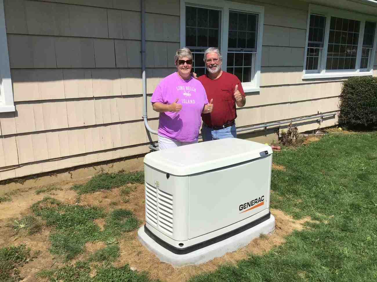 Happy customers beside their newly installed Generac generator for backup power in Blairstown, NJ