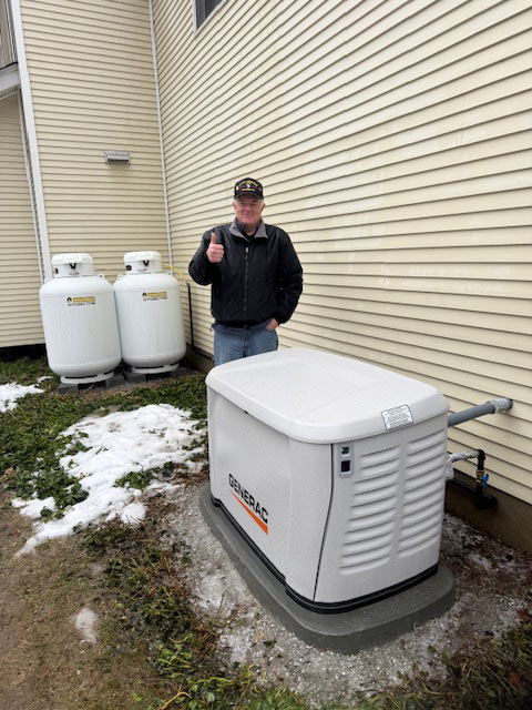 Generac standby generator with propane tanks the outside home in Blairstown, NJ