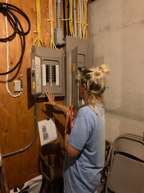 A women checking circuit board.