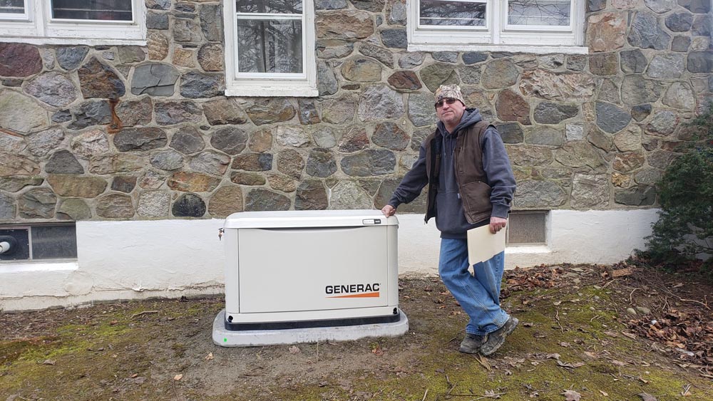 man standing by newly installed generator outside home